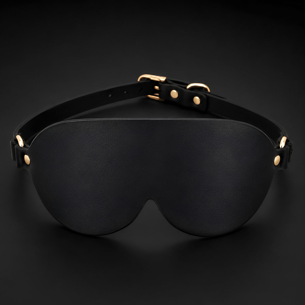 Front view of the Midnight Veil contoured black PU leather eye mask with an adjustable satin-touch band.