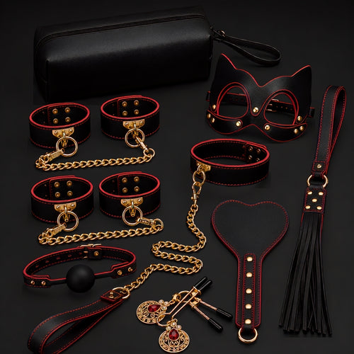The Eclipse Ritual red and black 10-piece bondage kit arranged with its black storage bag, cuffs, mask, paddle, flogger and accessories.